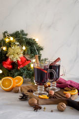 Christmas red mulled wine in glass on wood board at white background