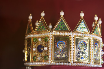 Golden crown with icons on a red background