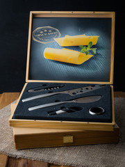 Set of steal knives for cutting cheese in wooden box