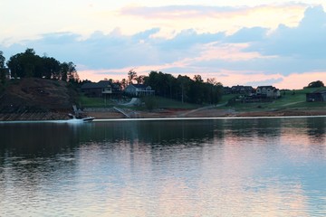 A end of the day at the lake with the setting sun over the land.