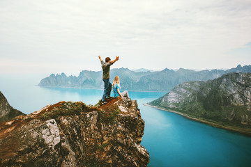 Travel couple enjoying view together on cliff edge in Norway man and woman family healthy traveling...