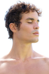 Profile portrait of a fit, bare-chested man with black hair and strong features