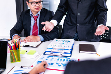 Business people discuss meeting with showing charts and graphs for idea presentation in office.