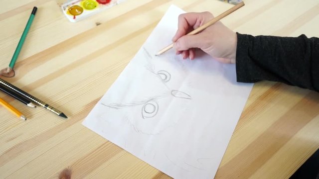 The artist draws a bird's head
