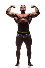 Fototapeta na wymiar powerful man shows off his biceps in Studio shirtless on white background