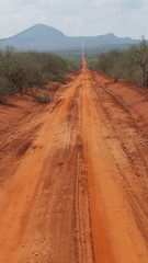 african infrastructure worse due to climate change - a road in Kenya in very bad condition after the rainy season due to erosion