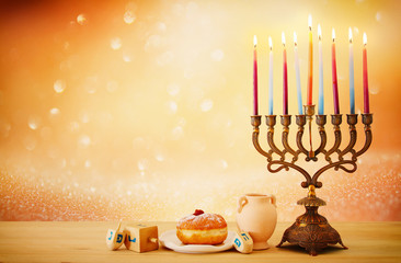 image of jewish holiday Hanukkah background with menorah (traditional candelabra) and candles over...