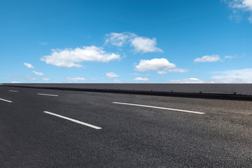 Fototapeta premium Empty highway asphalt pavement and sky cloud landscape..