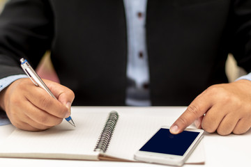 business man on cup paper coffee in hand with mobile phone