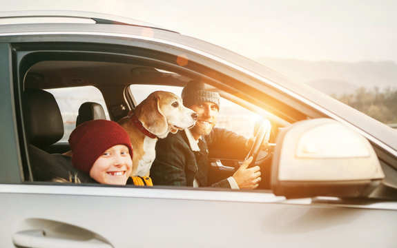 Father with son and beagle dog traveling together by auto right door angle shoot