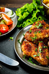 Roast chicken wings with french fries and vegetable salad 
