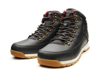 Dark black boots with shoelace on white background.