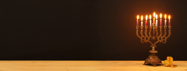 image of jewish holiday Hanukkah background with menorah (traditional candelabra) and candles. © tomertu