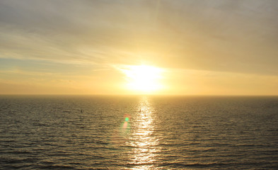 Sky Nature View of Sunset Over Calm Sea Water with Light Orange Cloudscape. Beautiful Sky Background at Sunset or Sunrise, Dusk or Dawn Panoramic Skyline View with Still Water on Summer Season Day