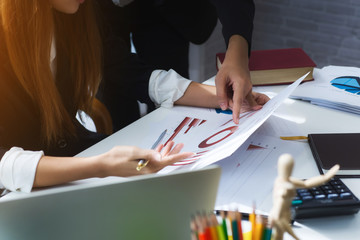 Photo of two confident business woman working looking at document graph for startup new project at office. Achieving best results of teamwork.