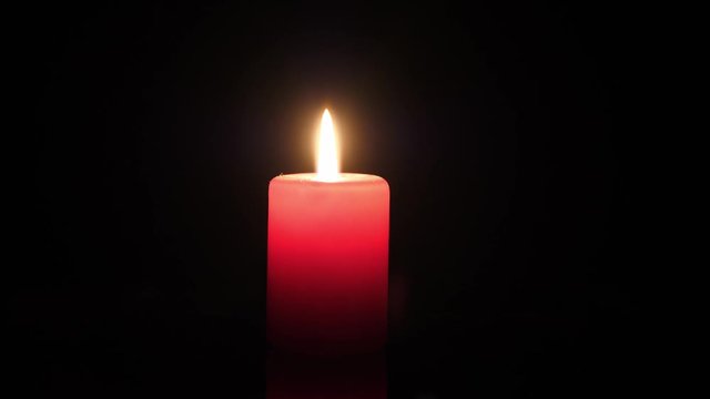 Typical background for mourning and hope - a burning candle