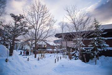 Shikotsuko onsen with full snow ground and sunset sky in winter at Lake Shikotsu, Chitose, Hokkaido, Japan