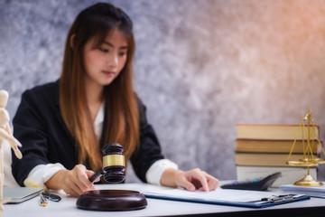 Women lawyer working with contract papers and wooden gavel on tabel in courtroom. justice and law ,attorney, court judge, concept.