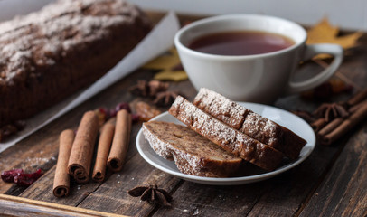Homemade banana bread with anis star and cinnamon on a dark wooden background