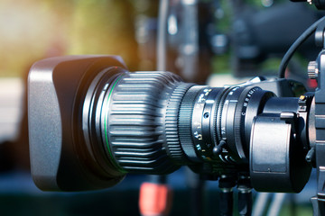 Fototapeta na wymiar Video camera lens - recording show outdoor TV studio - focus on camera aperture