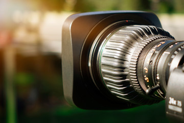 Fototapeta na wymiar Video camera lens - recording show in TV studio - focus on camera aperture