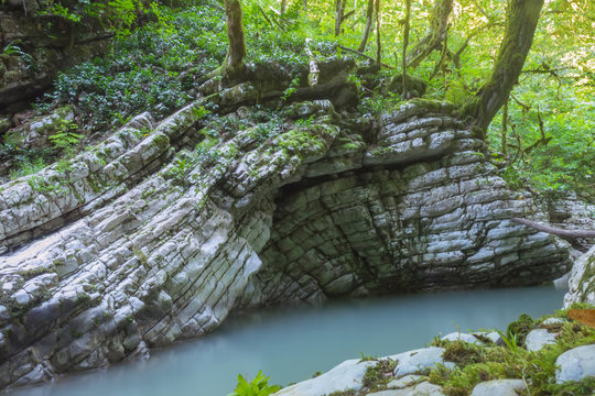 anticlinal fold of limestone over a mountain river. Caucasus nature reserve