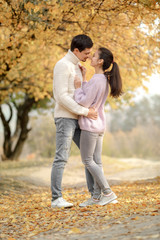 Fototapeta premium Couple in love in the autumn leaves