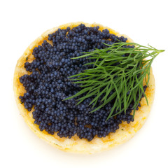 Canapes with black sturgeon caviar and  dill. Isolated on the white background.