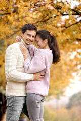 Fototapeta premium Couple in love in the autumn leaves
