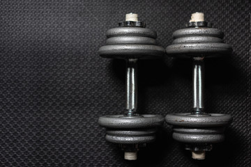Obraz na płótnie Canvas Top side View Weight dumbbell the floor in the gym with low light