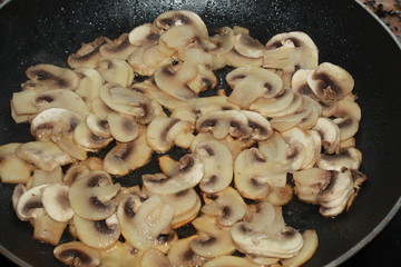 mushrooms fried in a pan 
