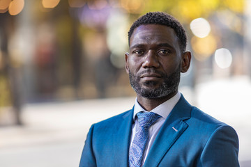 Portrait of handsome mature black male in a suit in the city - 232510766