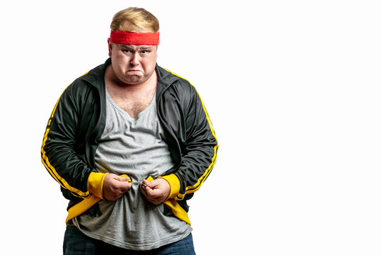 Middle age upset stressed fatty man with big belly unable to zip clothes due to gaining weight.