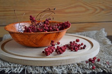 Useful Chinese lemongrass.Dried berry in a plate on a wooden background.