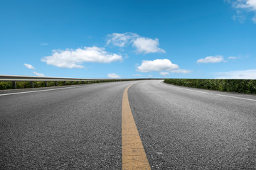 Empty highway asphalt pavement and sky cloud landscape..