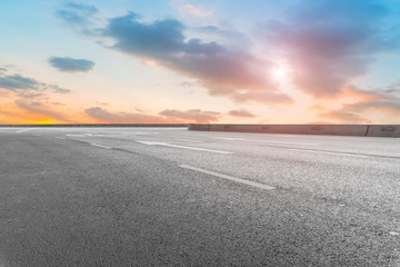 Empty highway asphalt pavement and sky cloud landscape..