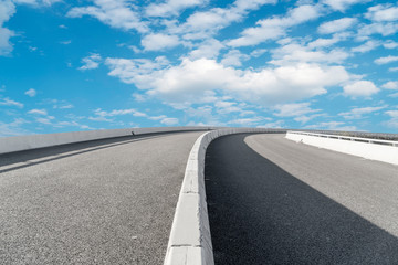 Empty highway asphalt pavement and sky cloud landscape..