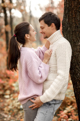 Couple in love in the autumn leaves