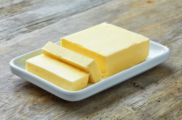 Sliced butter on wooden background