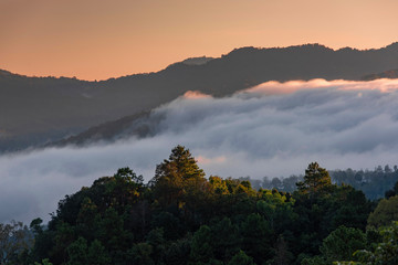 Mist covered mountains early morning Mae Hong Son Thailand.