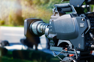 Video camera - recording show outdoor TV studio - focus on camera aperture