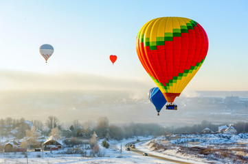 hot air balloons in the sky in winter