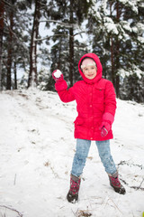 girl playing with snowballs