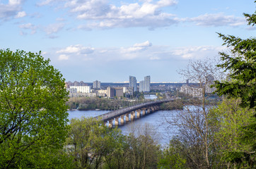 View of the city bridge across the river. Landscape of the summer city of Kiev.