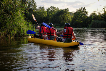 Three  man  enjoy water rafting activity at river. Rafting family on holidays