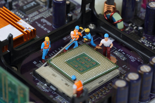 Selective focus of miniature engineer worker to fixed and repair CPU (Central Processing Unit๗,  mainboard computer as industry concept.