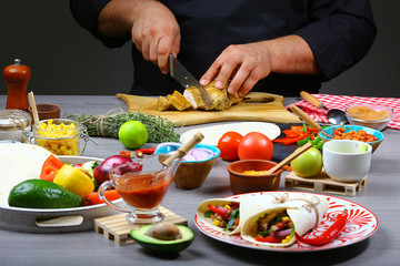 chef cooking burritos cutting meat, on a wooden board. Ingredients for cooking bureto, recipe