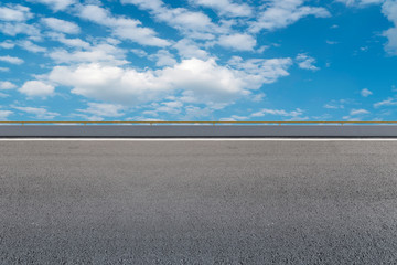 Empty asphalt road and natural landscape under the blue sky