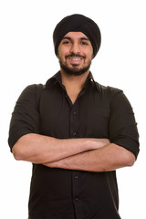 Portrait of young happy Indian Sikh man smiling