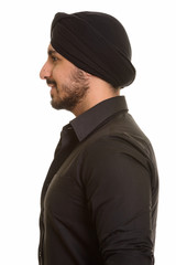 Profile view of young happy Indian Sikh smiling